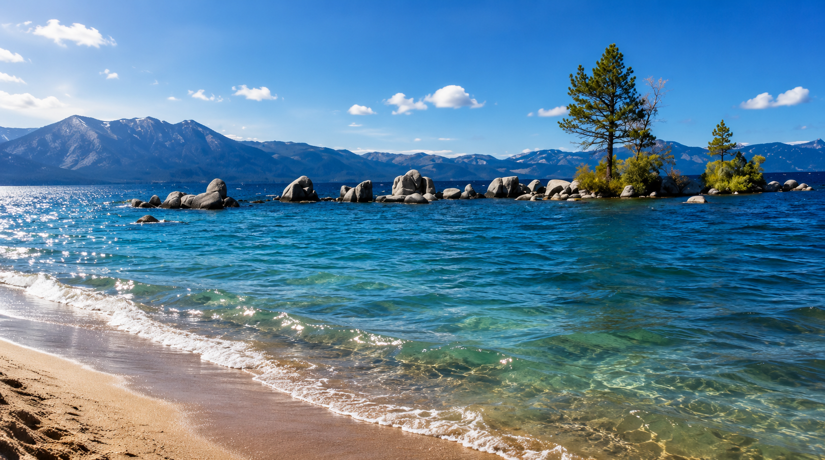 Snow-capped Sierra Nevada mountains across the sapphire water of Lake Tahoe