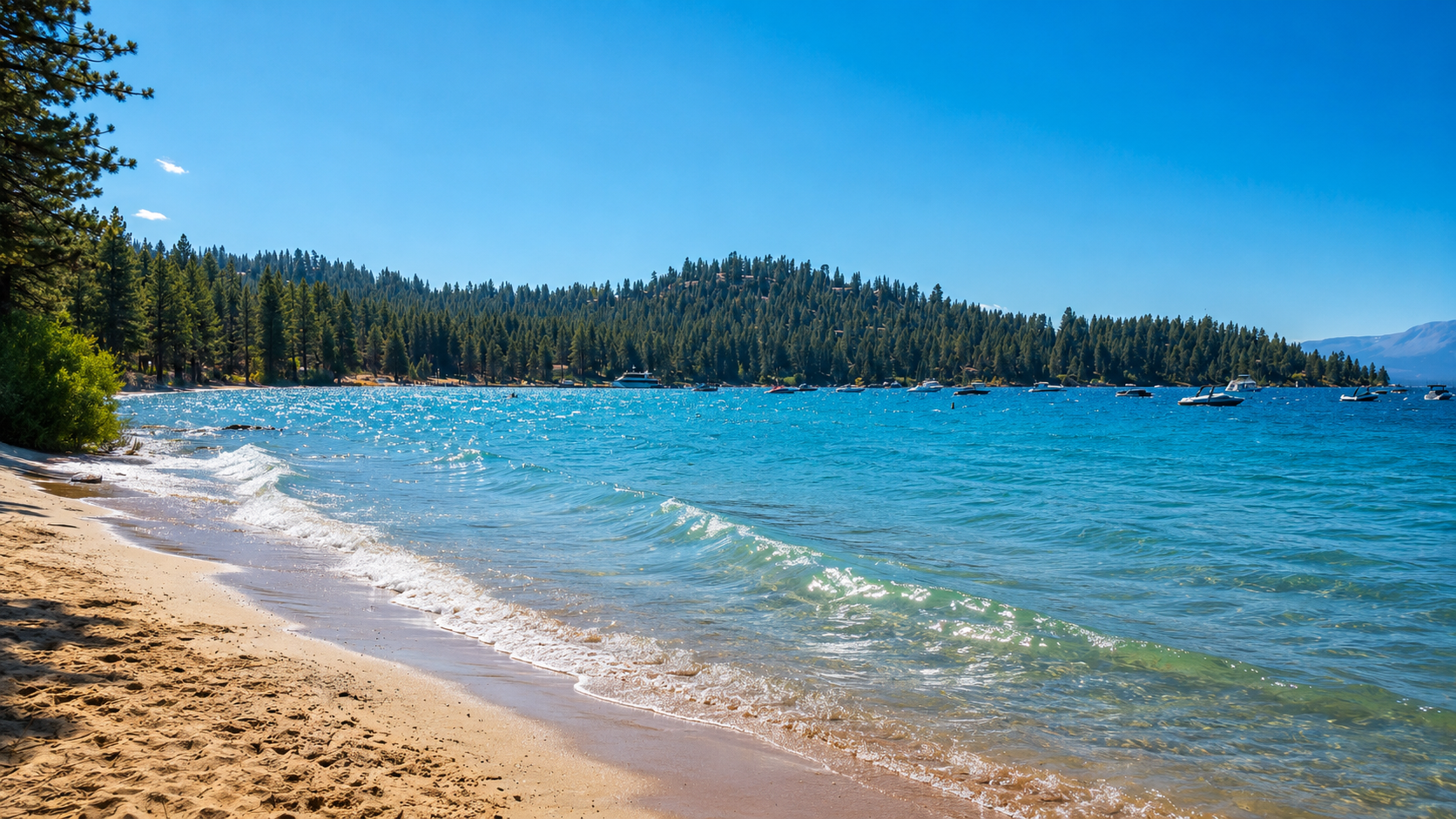 Gentle waves rolling onto the sandy shore of Lake Tahoe at Zephyr Cove